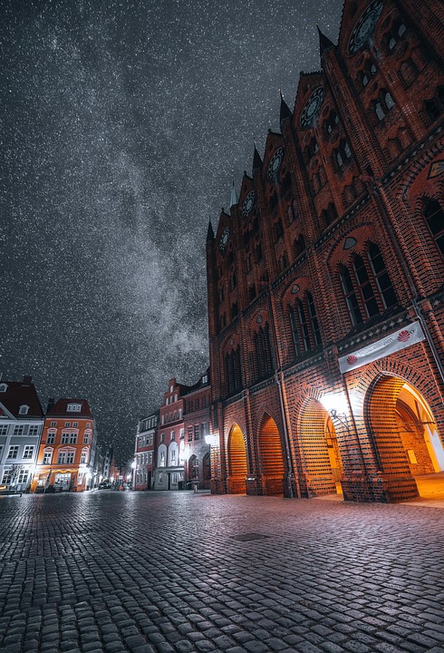 Nighttime square with red-brick building reference